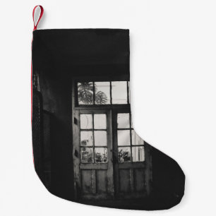 GRAYSCALE PHOTO OF WOODEN FRAMED CLEAR GLASS DOOR SMALL CHRISTMAS STOCKING