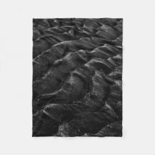 Grayscale photography of sand fleece blanket
