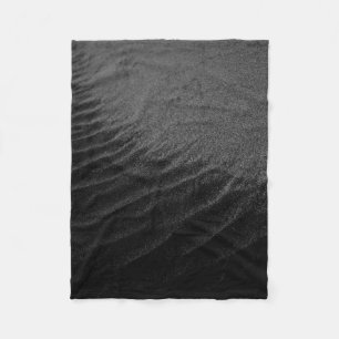 Grayscale photography of sand fleece blanket