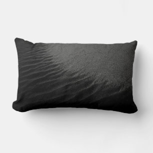 Grayscale photography of sand lumbar pillow