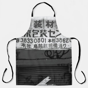 GRAYSCALE PHOTOGRAPHY OF STORE SIGN APRON