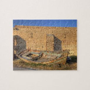 Greece, Santorini, Oia. Old fishing boat on dry Jigsaw Puzzle