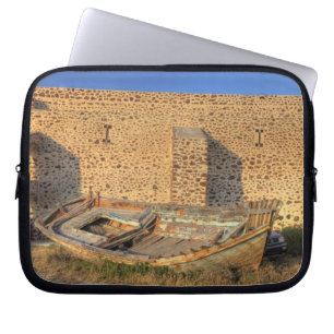 Greece, Santorini, Oia. Old fishing boat on dry Laptop Sleeve