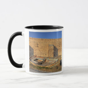 Greece, Santorini, Oia. Old fishing boat on dry Mug