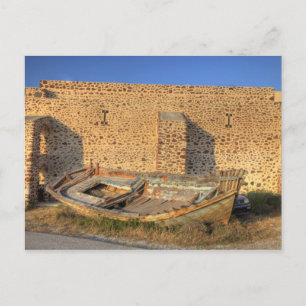 Greece, Santorini, Oia. Old fishing boat on dry Postcard