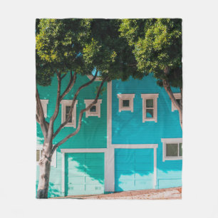 Green and blue houses beside trees on sidewalk fleece blanket