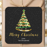 Green and Gold Ribbon Tree Merry Christmas Square Sticker<br><div class="desc">This elegant and chic holiday sticker can be personalized with your family name. The design features a green and gold ribbon Christmas tree with a star topper. The text combines handwritten script and modern sans serif fonts for a classy and sophisticated look. The falling snow, snowflakes and sparkles give a...</div>