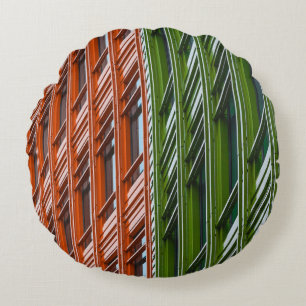 Green and red architectural structure round pillow