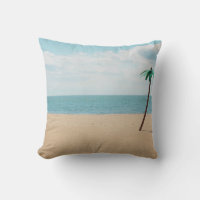 Green artificial palm tree on seashore