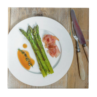 Green asparagus with ham and sauce tile