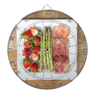 Green asparagus with ham and strawberries dartboard