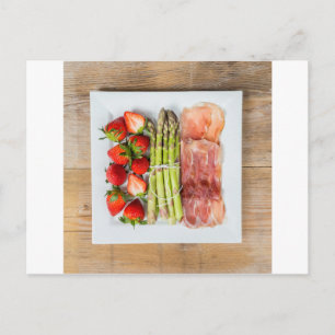 Green asparagus with ham and strawberries postcard