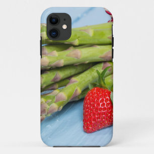 Green asparagus with strawberries on wooden iPhone 11 case