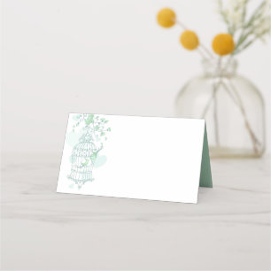 Green birds open cage graphic guest place cards