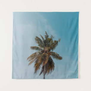 Green coconut tree under blue sky tapestry