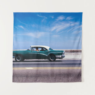 Green coupe on grey asphalt road tapestry