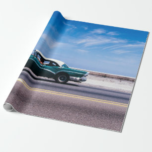Green coupe on grey asphalt road wrapping paper
