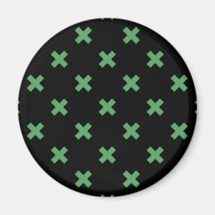 Green cross stitches on black magnet