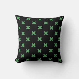 Green cross stitches on black throw pillow
