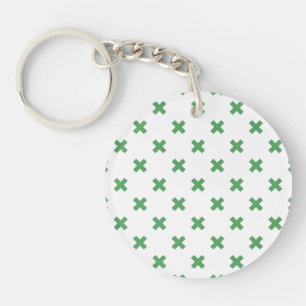 Green cross stitches on white keychain