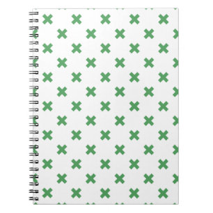 Green cross stitches on white notebook