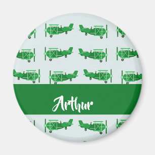 Green flying airplanes on blue magnet