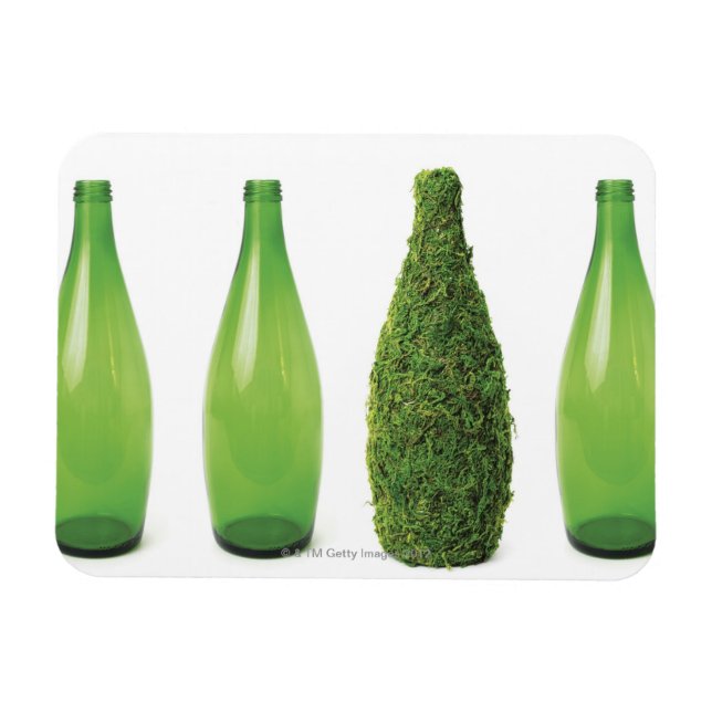 Green glass bottles showing recycling and magnet (Horizontal)