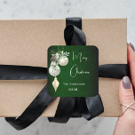 Green gold white baubles Christmas Square Sticker<br><div class="desc">For a Christmas party favours or gift wrapping. A rustic green uneven coloured background. Decorated with white and gold baubles and some greenery and a pine cone.  Personalize and add your name,  year.  Text: Merry Christmas</div>