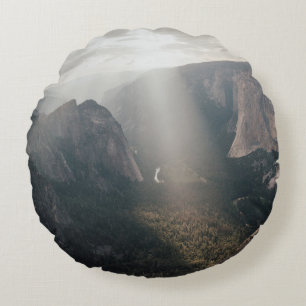 GREEN GRASS FIELD AND MOUNTAINS DURING DAYTIME ROUND PILLOW