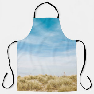 Green grass field under blue skies apron