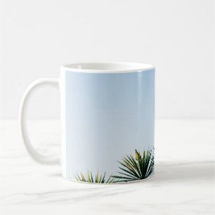 Green leaf plants under clear sky coffee mug