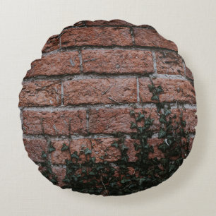Green-leafed plants near brick wall round pillow