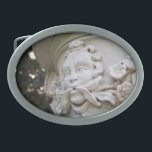 Green Man Oval Belt Buckle<br><div class="desc">The face with vines and flowers protruding from his mouth is known as a Green Man. In this colour photograph, the high relief sculpture is an architectural element that is part of a large planter atop a column. Shallow depth of field highlights the sculpture. Bokeh, out of focus circles of...</div>