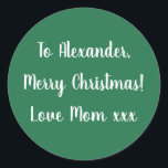 Green Merry Christmas from Mom gift tag sticker<br><div class="desc">Green Christmas gift tag label with the message Merry Christmas Love Mom xxx in white typography/ script. Simply change the name Alexander to your loved one's name in the personalize this text box. Want to make more changes? All of the text can be personalized. Or if you want to change...</div>