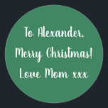 Green Merry Christmas from Mom gift tag sticker<br><div class="desc">Green Christmas gift tag label with the message Merry Christmas Love Mom xxx in white typography/ script. Simply change the name Alexander to your loved one's name in the personalize this text box. Want to make more changes? All of the text can be personalized. Or if you want to change...</div>