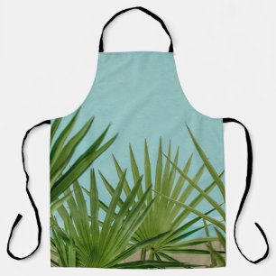 Green palm plant near body of water apron
