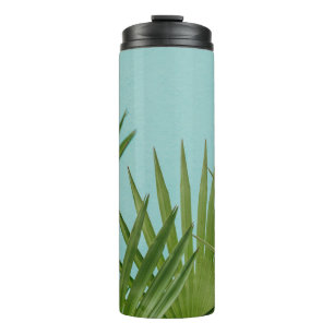 Green palm plant near body of water thermal tumbler