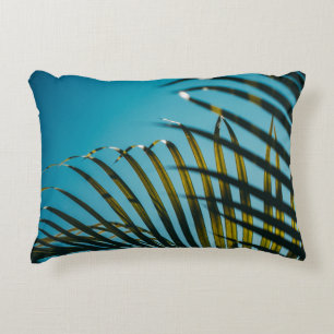 Green palm plant under blue sky in the morning accent pillow