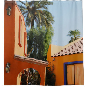 Green palm tree beside brown concrete building in