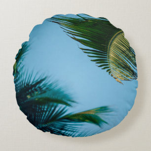 Green palm tree under blue sky in the morning round pillow