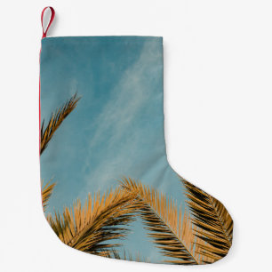 Green palm tree under blue sky in the morning small christmas stocking