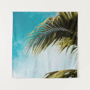 Green palm tree under blue sky tapestry