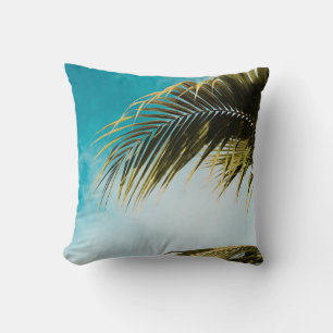 Green palm tree under blue sky throw pillow