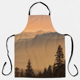 GREEN PINE TREES ON MOUNTAIN DURING DAYTIME APRON