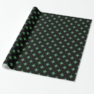 Green polka crosses on black wrapping paper