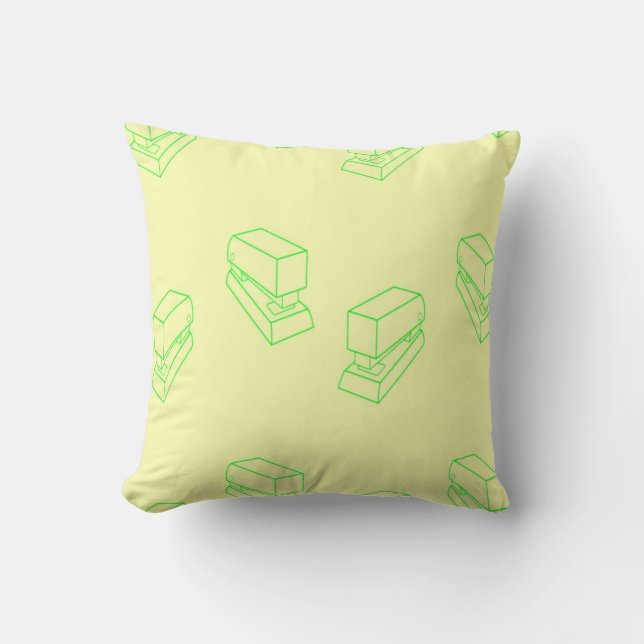 Green stapler on yellow throw pillow (Front)