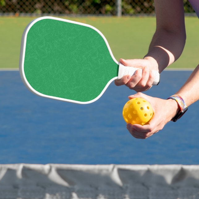 Green textured surface with  swirling pattern pickleball paddle (Insitu)