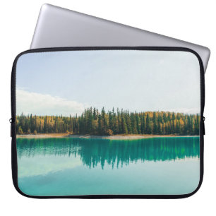 GREEN TREES BESIDE BODY OF WATER DURING DAYTIME LAPTOP SLEEVE