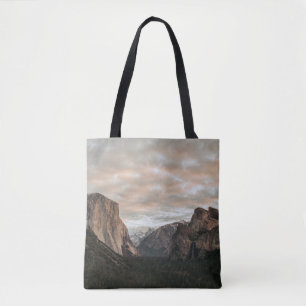 GREEN TREES NEAR BROWN MOUNTAIN UNDER CLOUDY SKY D TOTE BAG