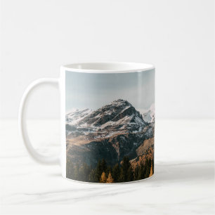GREEN TREES NEAR SNOW COVERED MOUNTAIN DURING DAYT COFFEE MUG